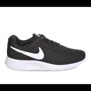 black and white NIKE tennis shoes